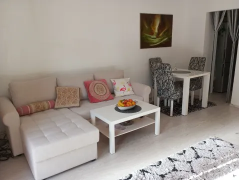 Living room with a sectional sofa, coffee table, and dining area. - image 5