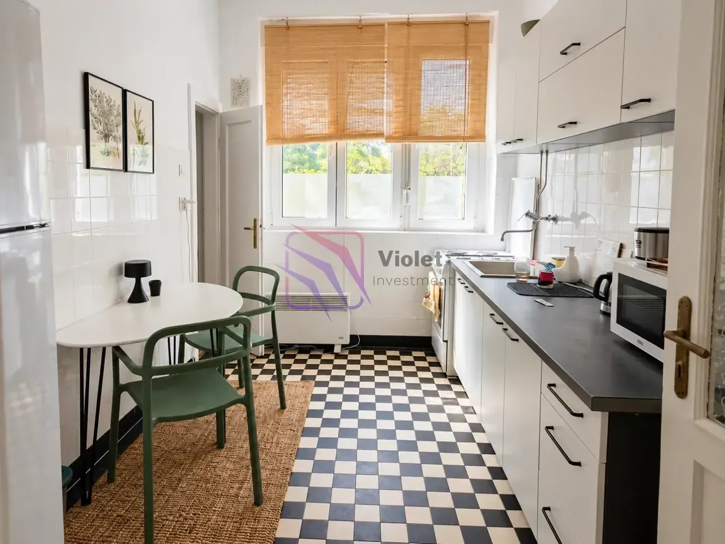 Kitchen with a dining table and a black and white checkerboard floor.