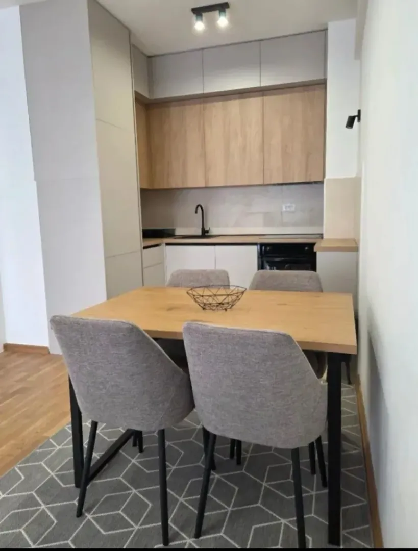 Modern kitchen with a dining table and chairs.