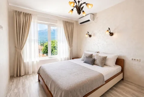 Bright bedroom with a double bed and a nature view. - image 7