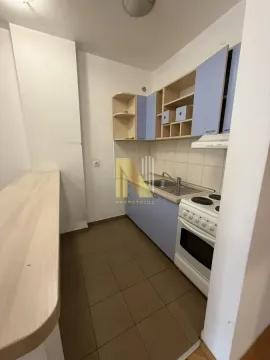 Smaller kitchen with blue cabinets and a breakfast bar. - image 5