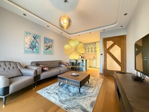 Modern living room with a sofa and a view of the kitchen. - image 2