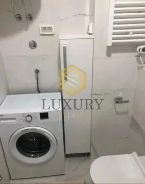 View of the bathroom with a washing machine and sanitary fixtures. - image 5