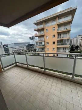 Spacious terrace with a view of surrounding buildings. - image 6