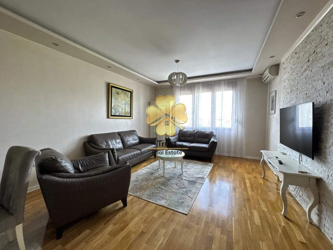 Spacious living room with seating set and TV cabinet.