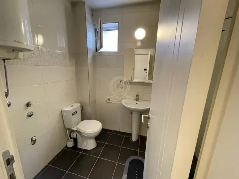 Smaller bathroom with white tiles, sink and toilet. - image 9
