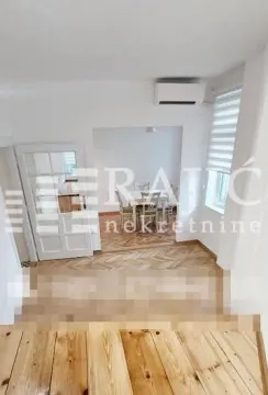 Living room with dining area and wooden flooring. - image 4