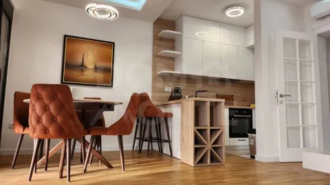 Modern kitchen with a dining area and built-in appliances. - image 5