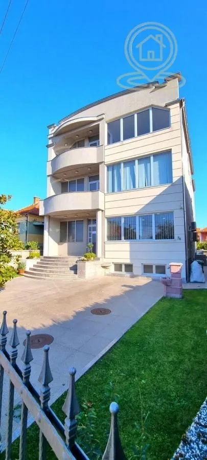 Front view of the residential building with a landscaped yard and entrance.