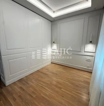 Modern bedroom with a built-in wardrobe and wooden flooring. - image 7