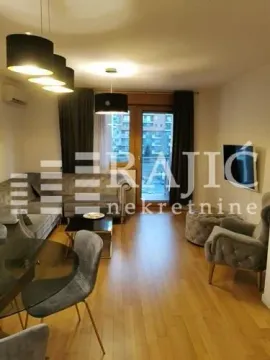 Living room with a sofa, dining table, and access to the terrace. - image 8