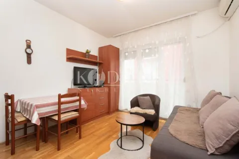 Living room with sofa, dining table and television. - image 2