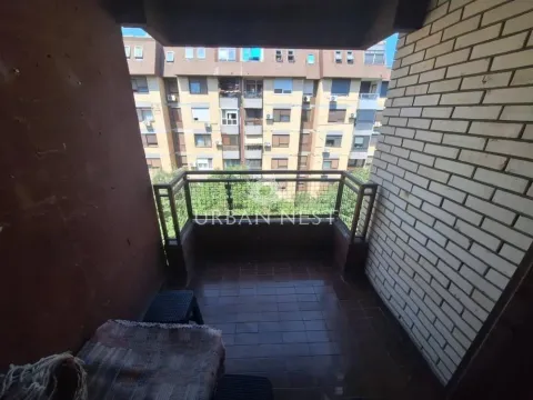 Covered balcony with a view of the neighboring building. - image 4