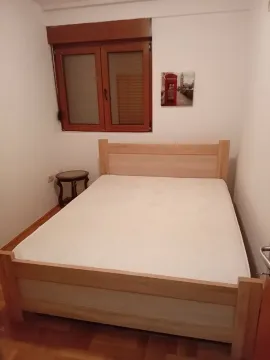 Small bedroom with a double bed, a window, and a bedside table. - image 6