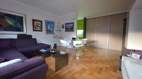 Living room with a sofa set, dining table and parquet flooring. - image 6