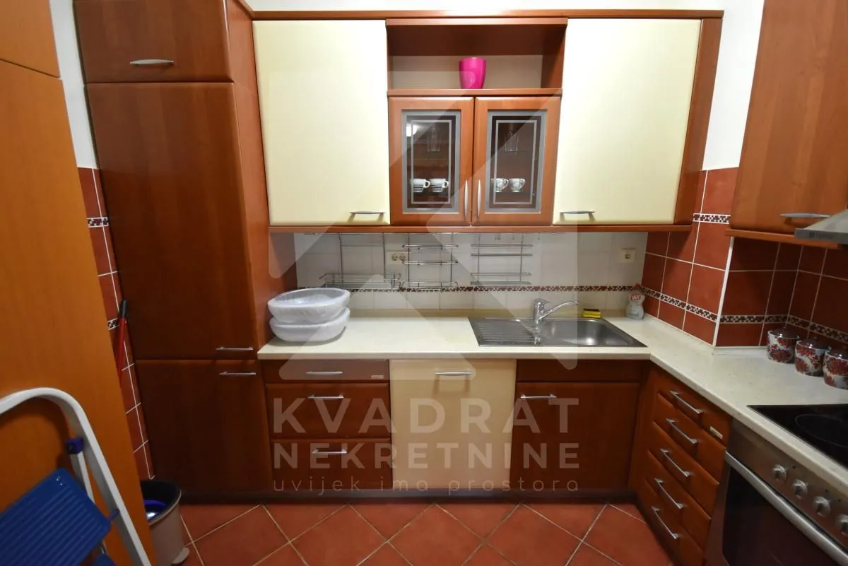 Kitchen equipped with wooden cabinets and a sink.