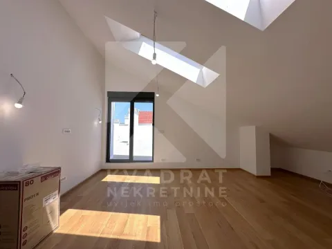 Empty attic room with wooden flooring and skylights. - image 19