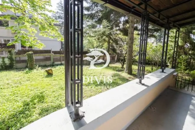 Covered terrace with a view of the landscaped courtyard and greenery.