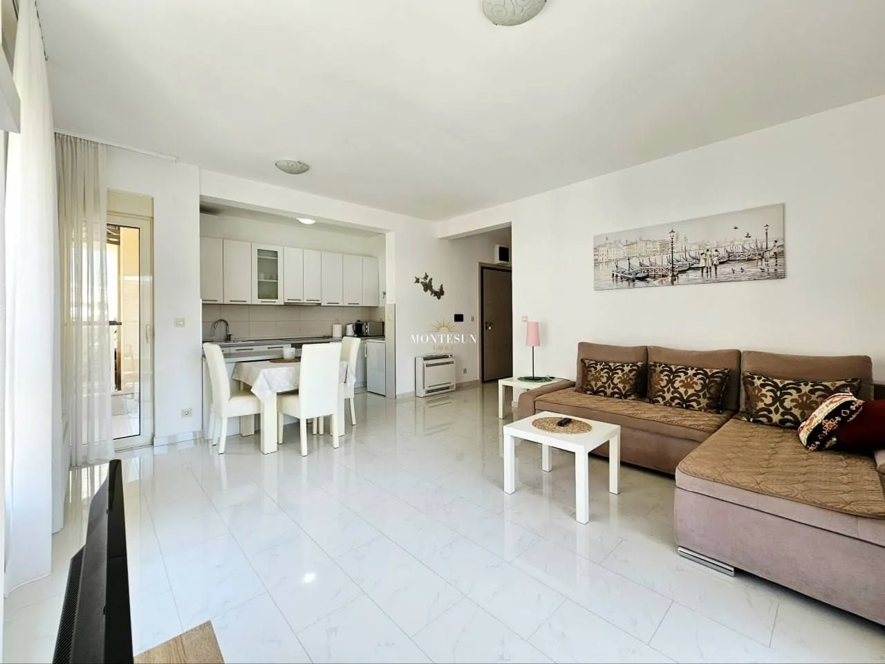 Spacious living room with dining area and open-plan kitchen.