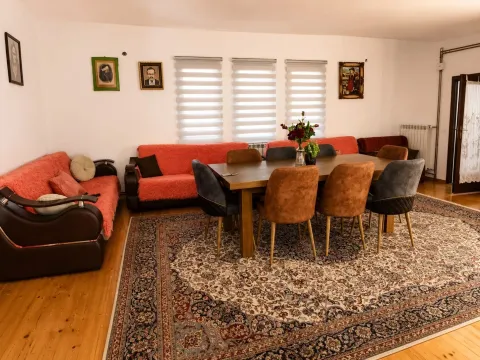 Spacious living room with a seating set, dining table, and chairs. - image 6
