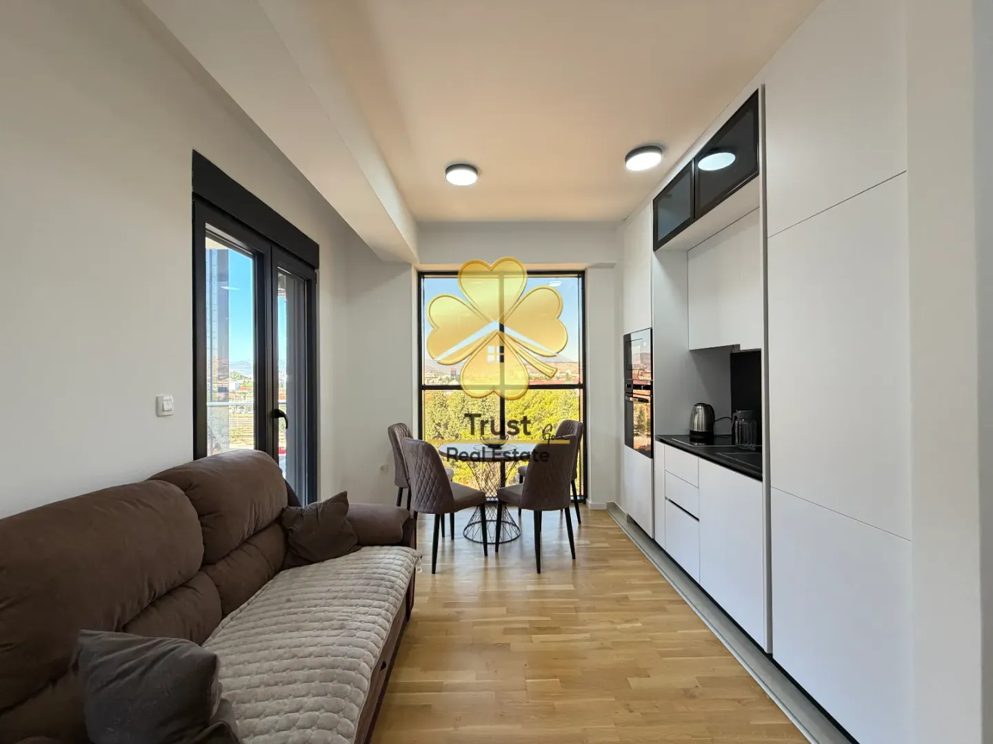 Modern living room with kitchen and dining area.