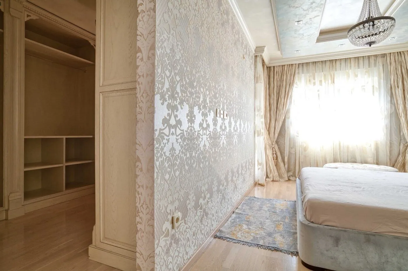 Spacious bedroom with a double bed and built-in wardrobe.