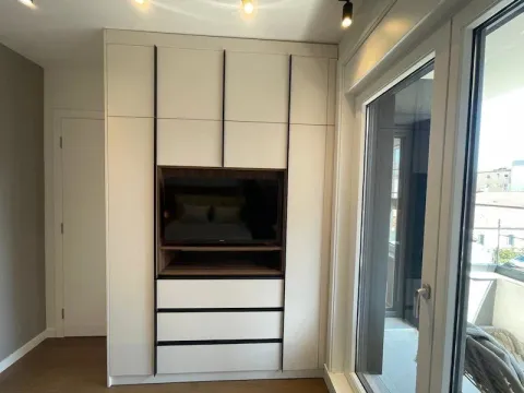 Bedroom with a built-in wardrobe and TV panel. - image 15