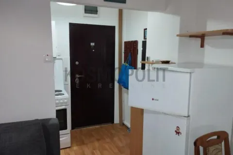 Smaller kitchen with a refrigerator and a stove within the apartment. - image 6