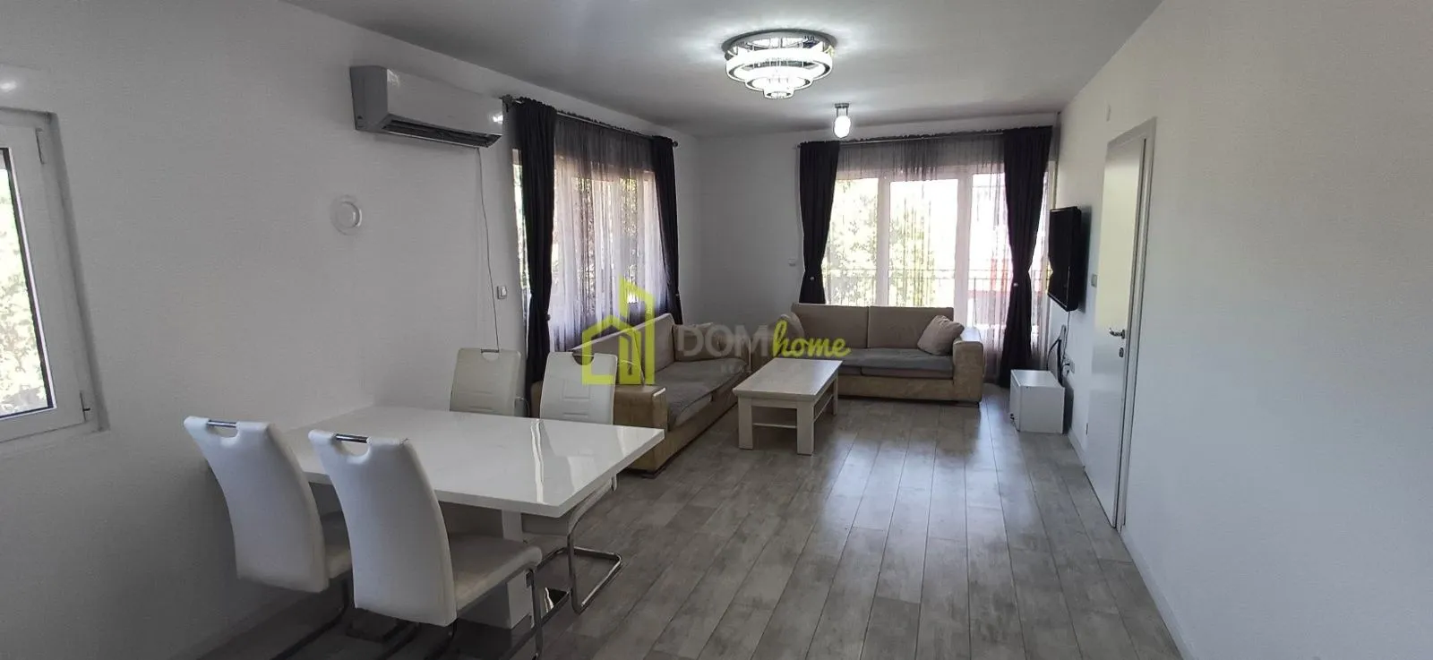 Spacious living room with a sofa set and dining table.
