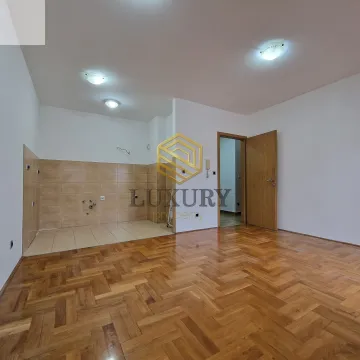 Empty room with parquet flooring and a prepared kitchen area. - image 2