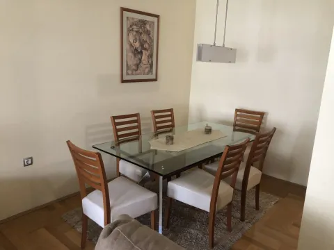 Dining area featuring a glass-top table and wooden chairs. - image 7