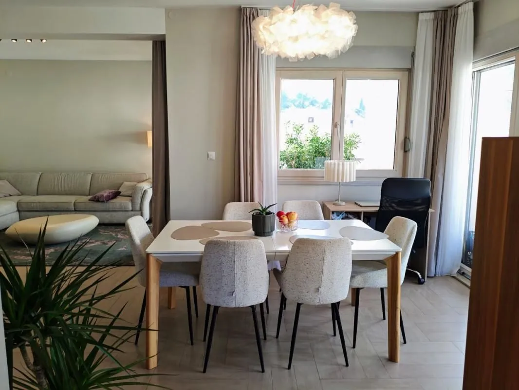 Dining area with a table and chairs, overlooking part of the living room.