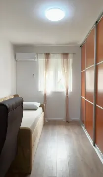Smaller bedroom with a bed and a large fitted wardrobe. - image 10