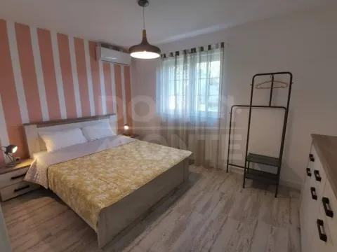 Bright bedroom with a double bed and a striped accent wall. - image 6