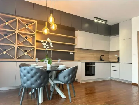Modern kitchen with a dining area and built-in elements. - image 2