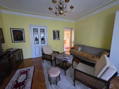 Living room with a sofa, armchairs, and a dining area in the background. - image 7