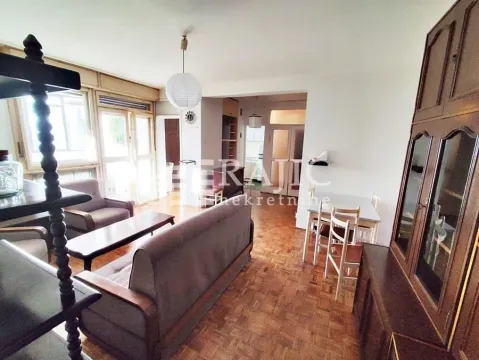 Furnished living room with dining area and wooden flooring. - image 2