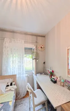 Children's room with a bed, desk, and a window. - image 8