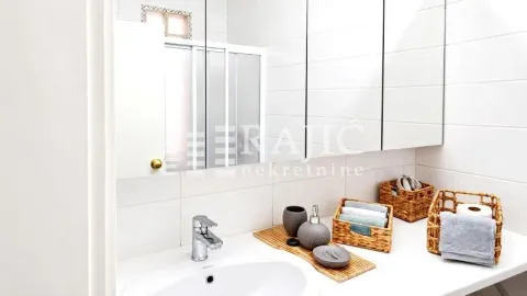 View of the bathroom with a sink and mirror. - image 6
