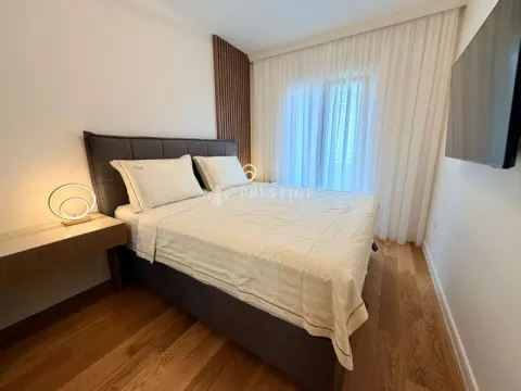 Modern bedroom with a double bed, wooden flooring, and a wall-mounted TV. - image 8