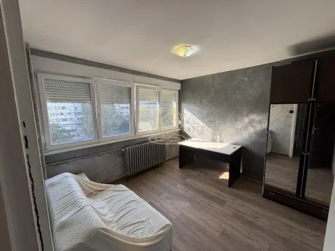 Furnished bedroom with a bed, desk, and wardrobe. - image 6