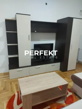 Living room with a TV and wooden furniture. - image 5