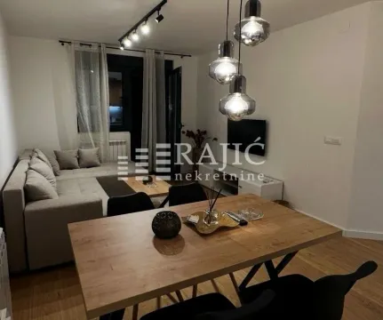 Living room with dining area and modern lighting. - image 4
