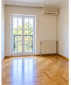 Empty room with parquet flooring, air conditioning, and balcony doors. - image 18