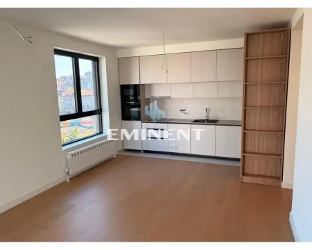 Empty kitchen with built-in cabinetry and hardwood flooring. - image 20