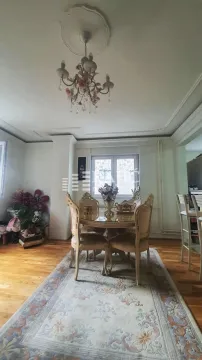 Dining area with a table, chairs, and a chandelier in a furnished interior. - image 3