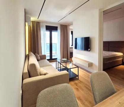 Modern living room with a sofa, coffee table, and a view of the terrace. - image 2