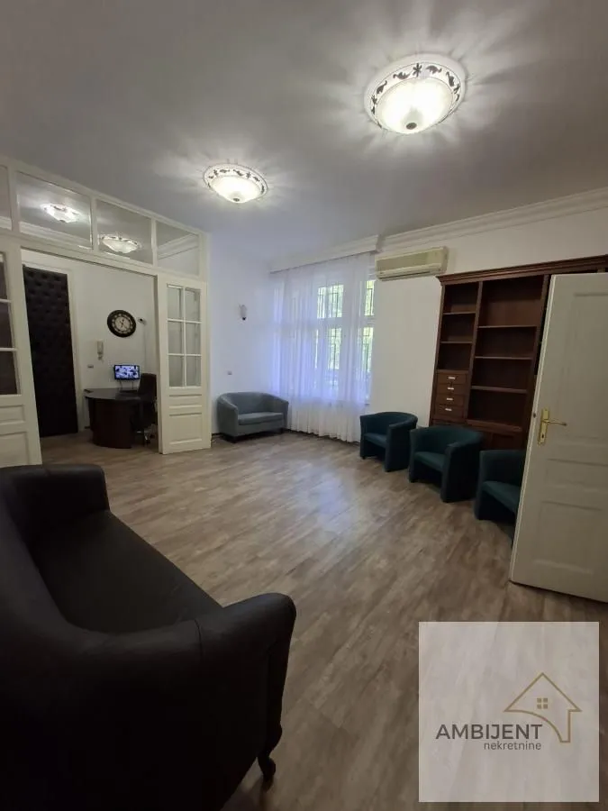 Spacious living room with seating furniture and a window view.
