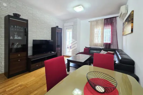 Living room with a sofa, TV, and dining table. - image 14