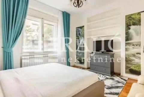 Bright bedroom with a large double bed and a window. - image 9